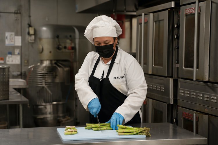 A chef cutting produce 