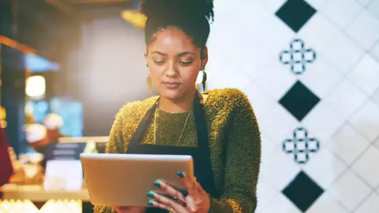 worker looking at a tablet at work