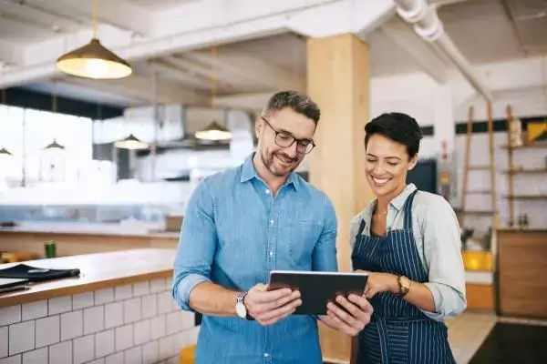 Team members using tablet to conduct work